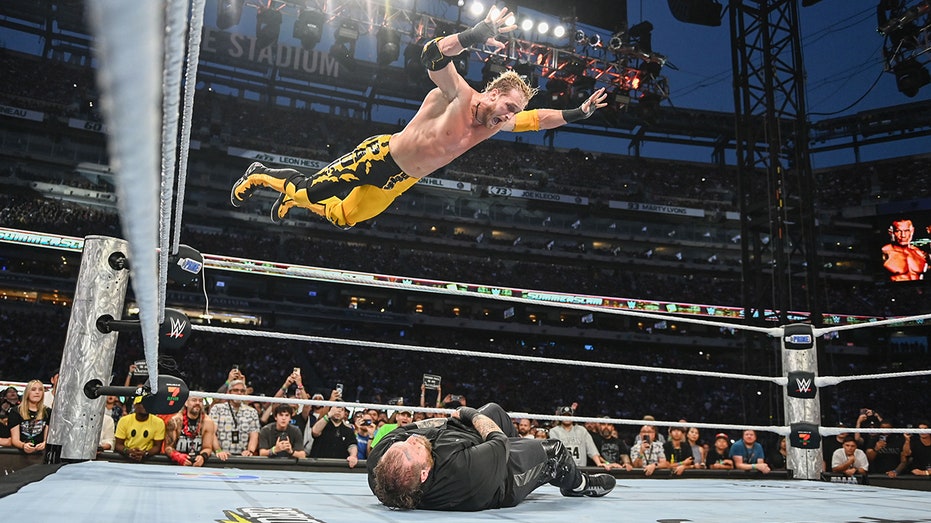 logan-paul-provides-highlight-reel-moment-with-frog-splash-onto-jelly-roll-through-table-at-summerslam