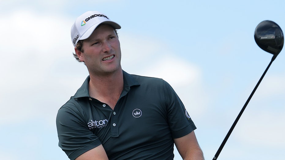 alligator-keeps-close-eye-on-pga-tour-golfer-vince-whaley-while-he-takes-swing-near-water